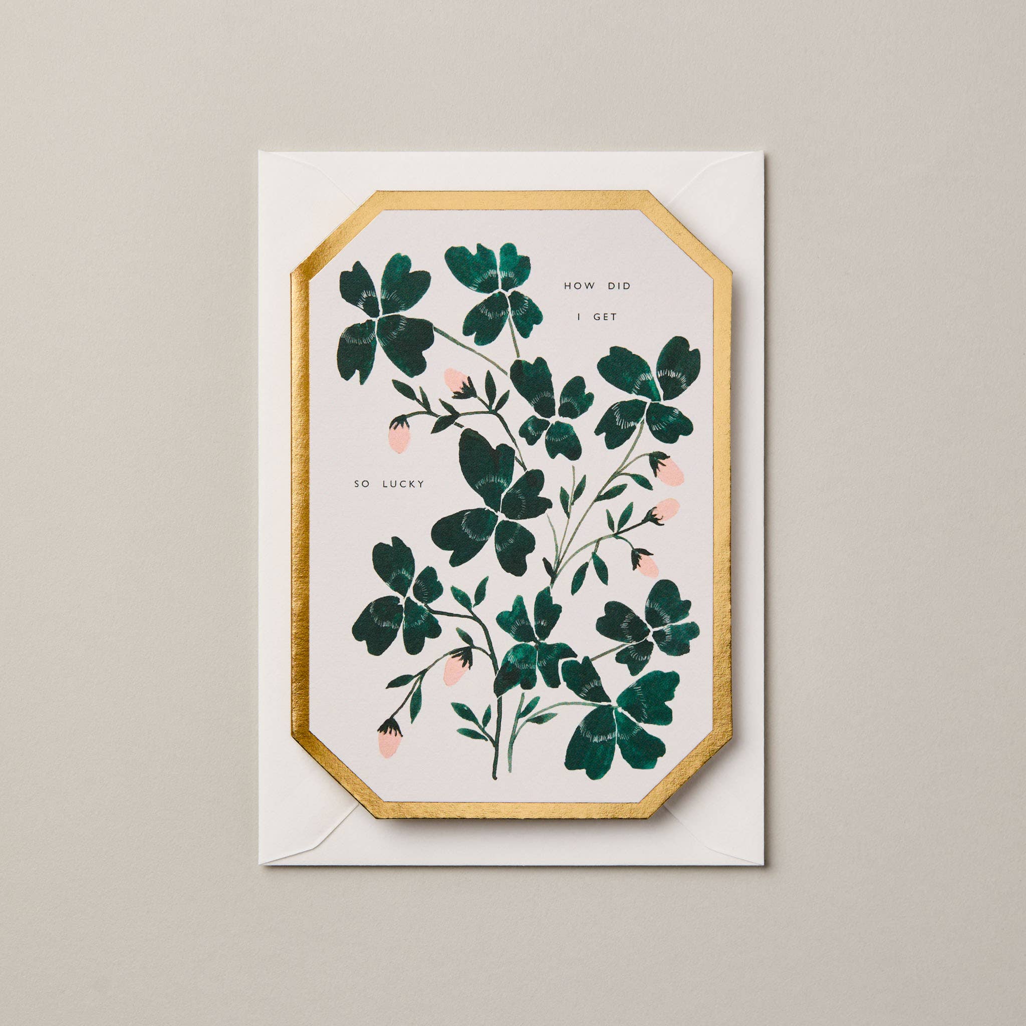 Greeting card with floral design and gold border on a beige background