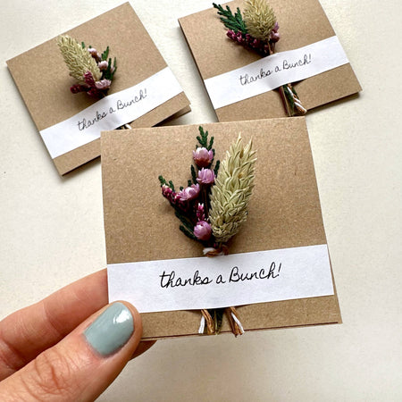 Three handmade cards with floral decorations and 'thanks a Bunch!' text on a light background.