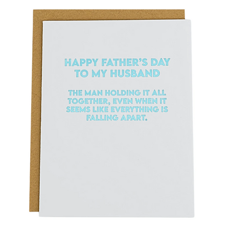 father's day card that reads "Happy fathers day to my husband. The man holding it all togther, even when it seems like everything is falling apart"
with metallic light blue lettering on a white background