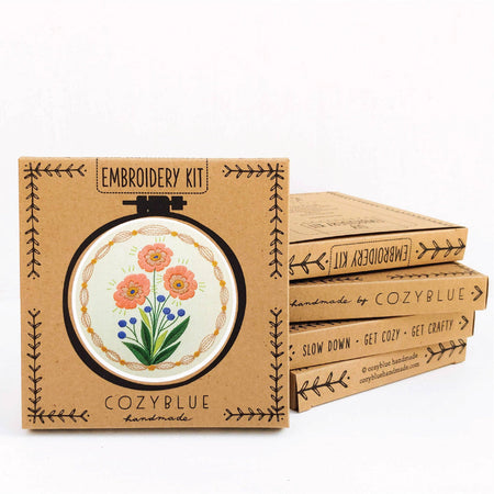 Embroidery kit packaging with floral design and 'CozyBlue' branding on a white background