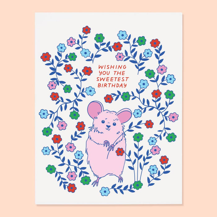 Greeting card with a pink mouse surrounded by colorful flowers and text on a light pink background