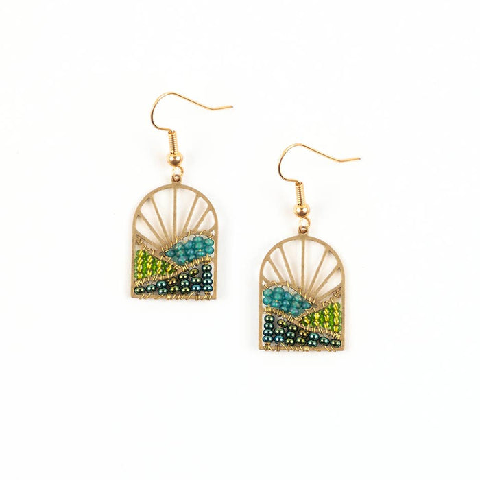 Gold-framed earrings with green and blue bead details on a white background