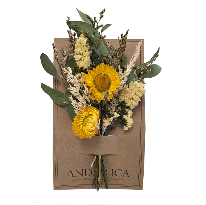 Bouquet of yellow and green flowers in a brown paper bag with 'ANDALUCIA' branding.