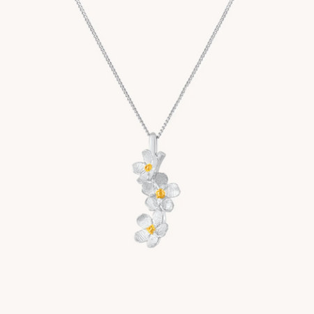 Silver necklace with cherry blossom drop with gold centers on a white background