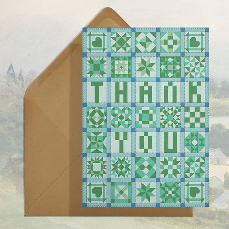Card with quilt-style design and 'THANK YOU' text, featuring a brown envelope.