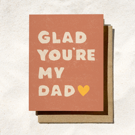 Greeting card with 'Glad you're my dad' text and a heart on a textured background