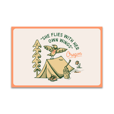 Card with a cartoon bird, tent, and trees with text 'She flies with her own wings. Oregon' on a white background.