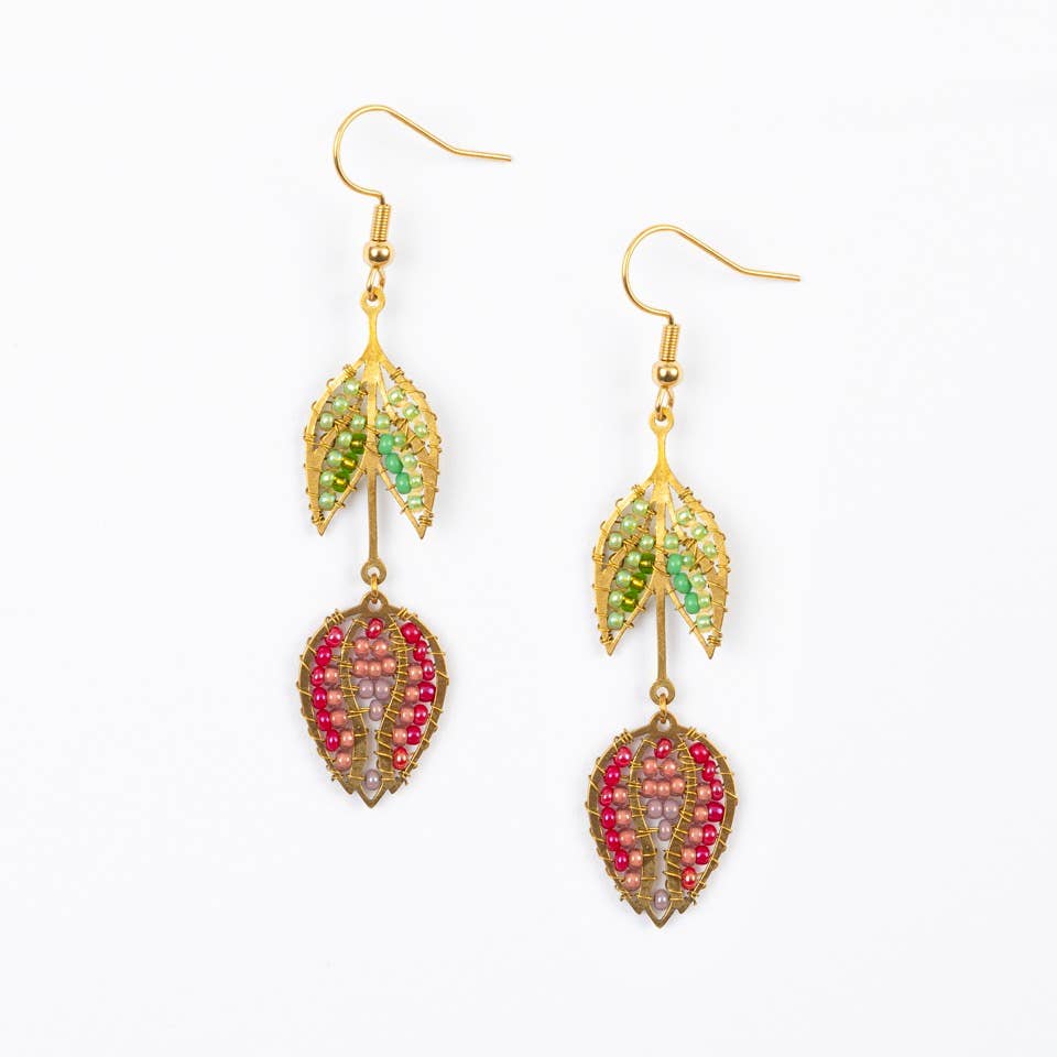Tulip-shaped earrings with green and pink beads on a white background