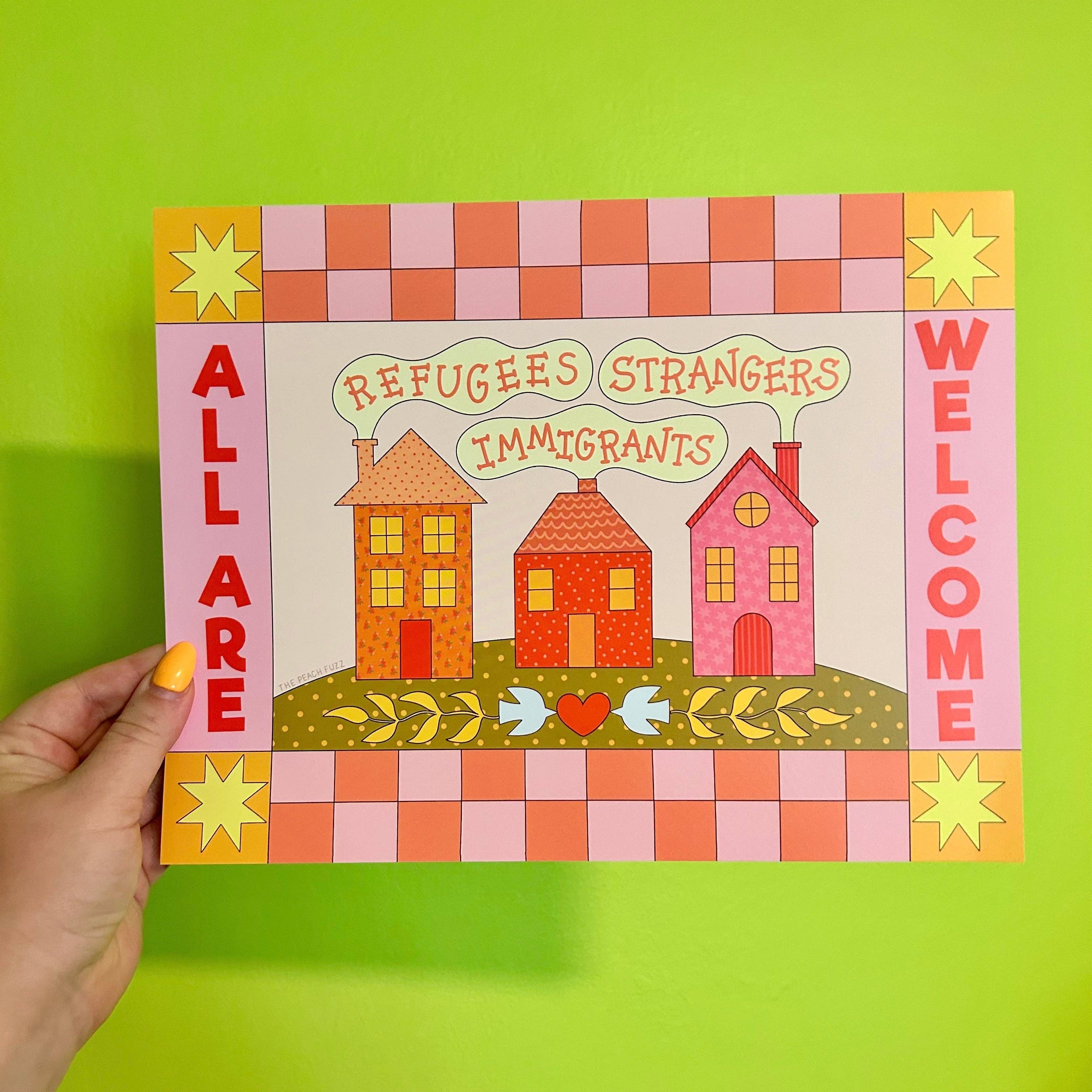Hand holding a colorful poster with houses and text on a green background