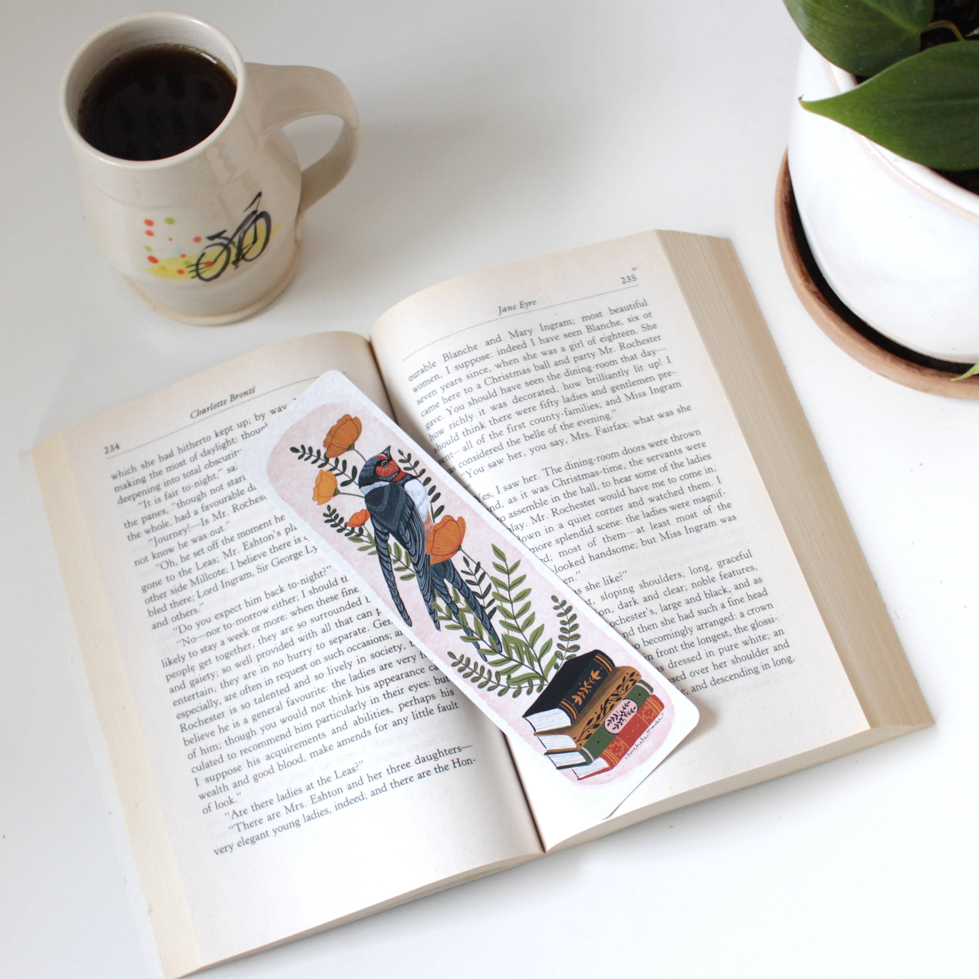 decorative paper bookmark with bird, books and flowers on an open book