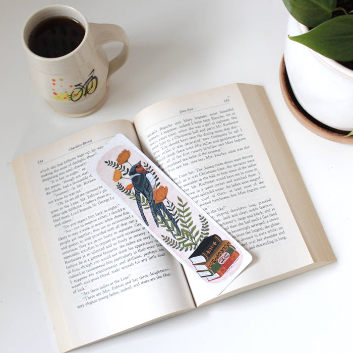 decorative paper bookmark with bird, books and flowers on an open book