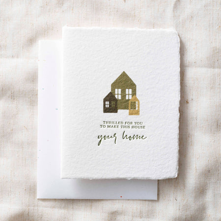 Greeting card with house illustration and text on a textured fabric background