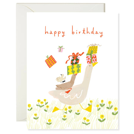 Greeting card with a duck holding a gift, surrounded by flowers and 'happy birthday' text.