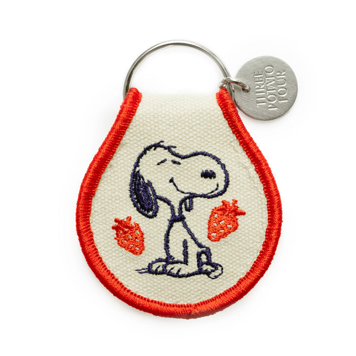 Keychain with embroidered design of snoopy with strawberries on a white background