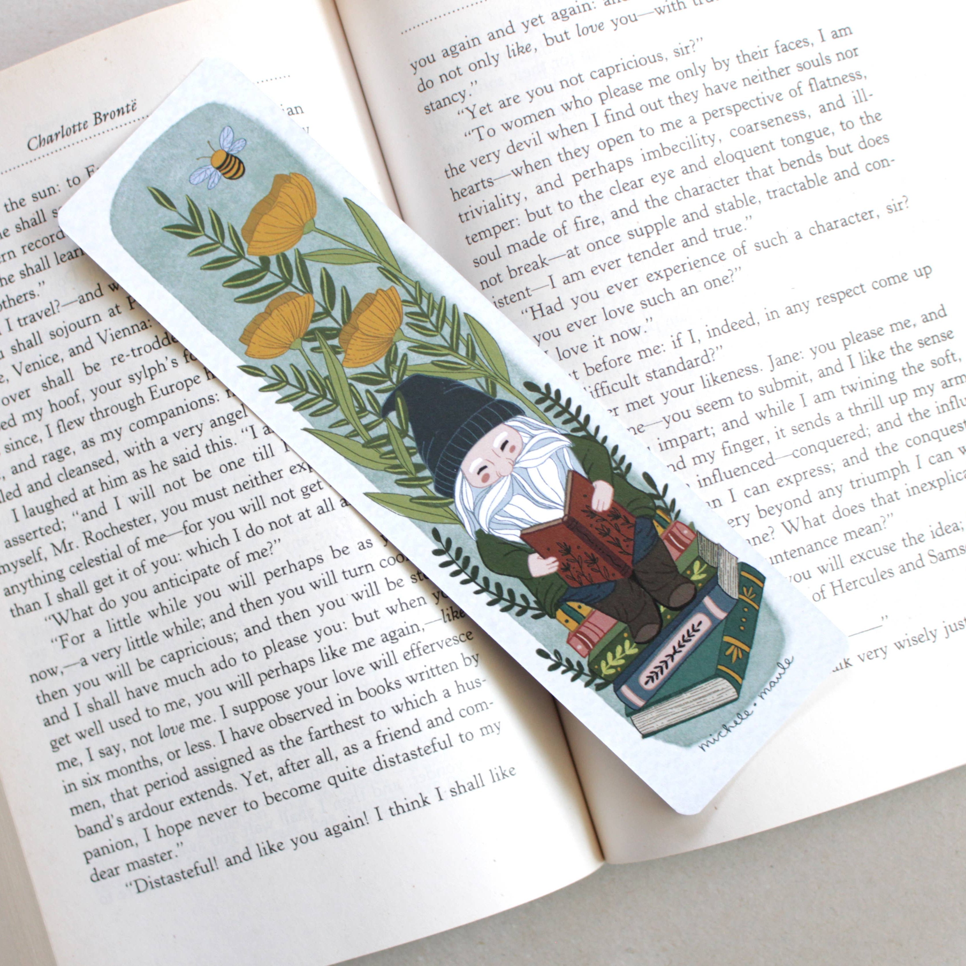 paper bookmark that has flowers + gnome illustrations and is double sided 