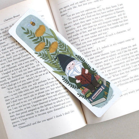 paper bookmark that has flowers + gnome illustrations and is double sided 