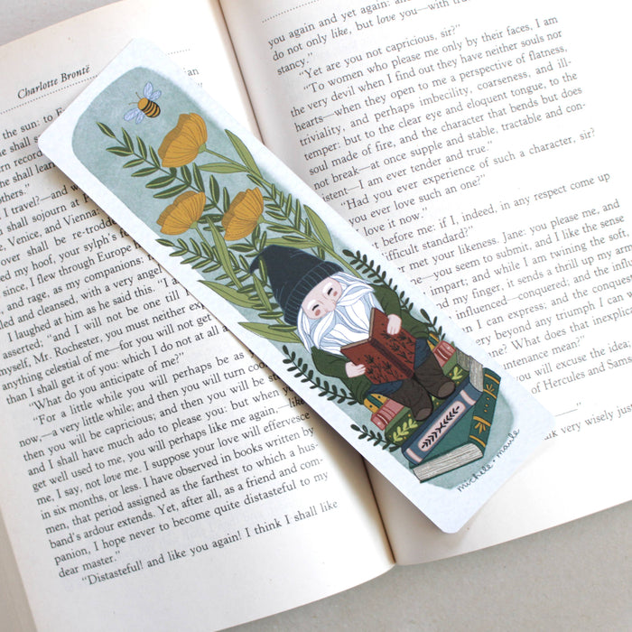 paper bookmark that has flowers + gnome illustrations and is double sided 