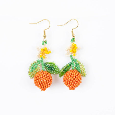 Beaded earrings with orange and green design on a white background