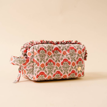 Floral-patterned toiletry bag on a beige background