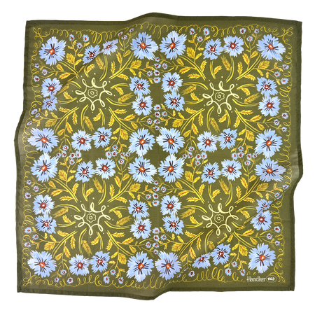 Floral patterned fabric with blue flowers and green leaves on a white background