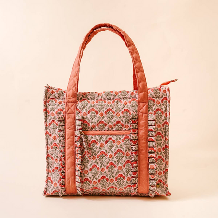 Patterned tote bag with orange accents on a beige background