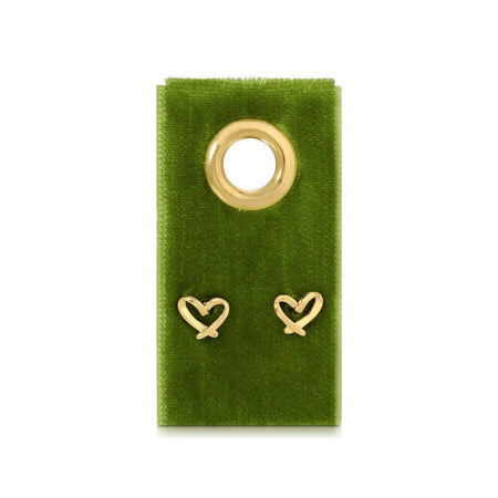 Gold heart-shaped earrings on a green velvet card with a gold ring.