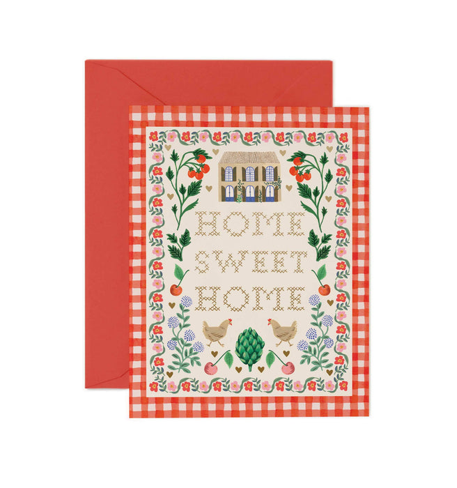 Greeting card with 'Home Sweet Home' text and house illustration on a red checkered background