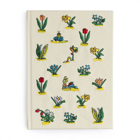 Notebook with colorful floral illustrations on a beige background