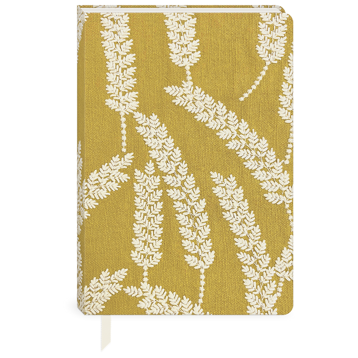 Notebook with white leaf pattern on a mustard yellow background