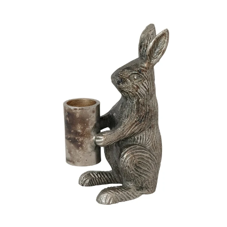 Decorative metal rabbit taper candle holder on a white background