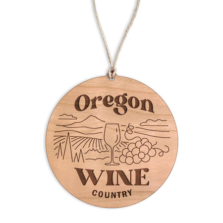 Wooden ornament with 'Oregon Wine Country' engraving on a white background