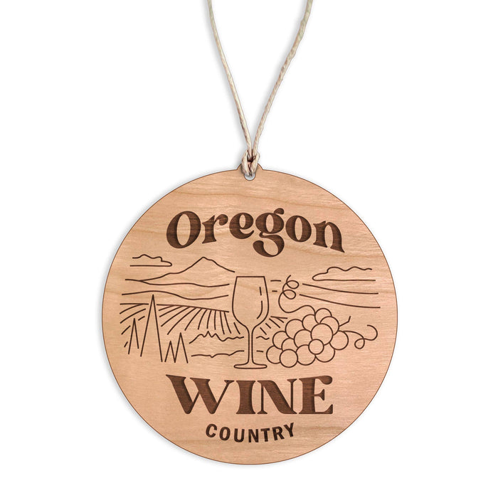 Wooden ornament with 'Oregon Wine Country' engraving on a white background