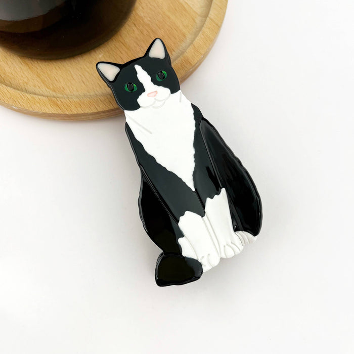 Black and white cat-shaped object on a white background