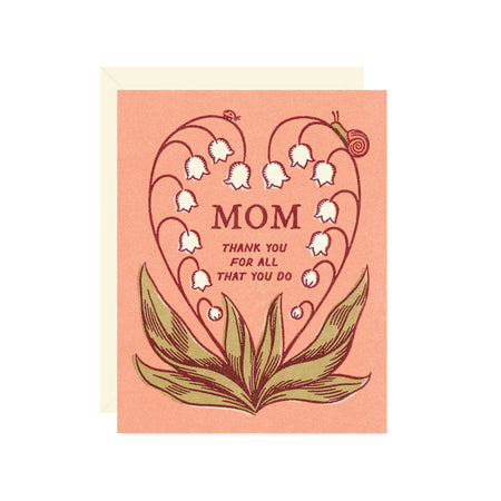 Greeting card with floral design and 'Mom' text on a pink background
