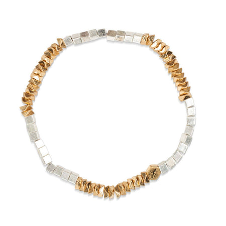 Bracelet with gold and silver beads on a white background