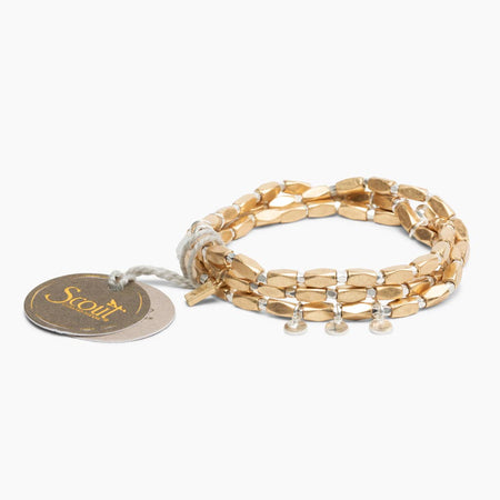 Gold bracelet with a tag on a white background
