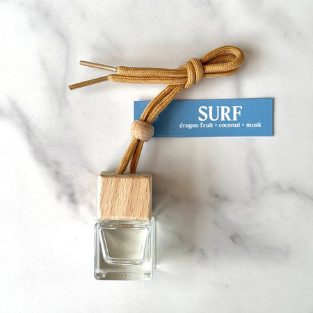 diffuser bottle with wooden cap and rope on a marble surface