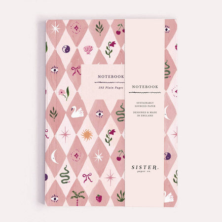 Notebook with decorative cover featuring geometric patterns and illustrations on a white background