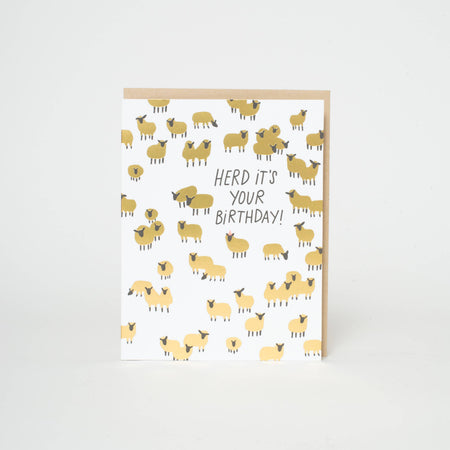 Greeting card with sheep pattern and 'Herd it's your birthday!' text on a white background