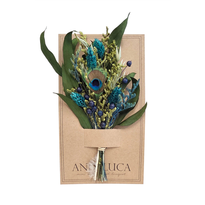 Bouquet of dried flowers with a peacock feather in a brown paper packaging on a white background