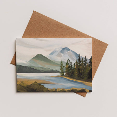 Greeting card with mountain and lake illustration on a brown envelope