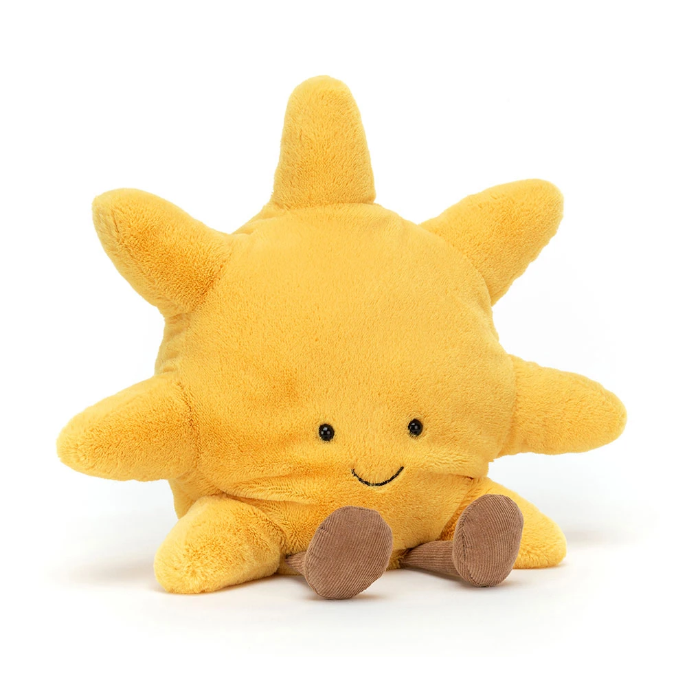Yellow plush sun toy with a smiling face on a white background