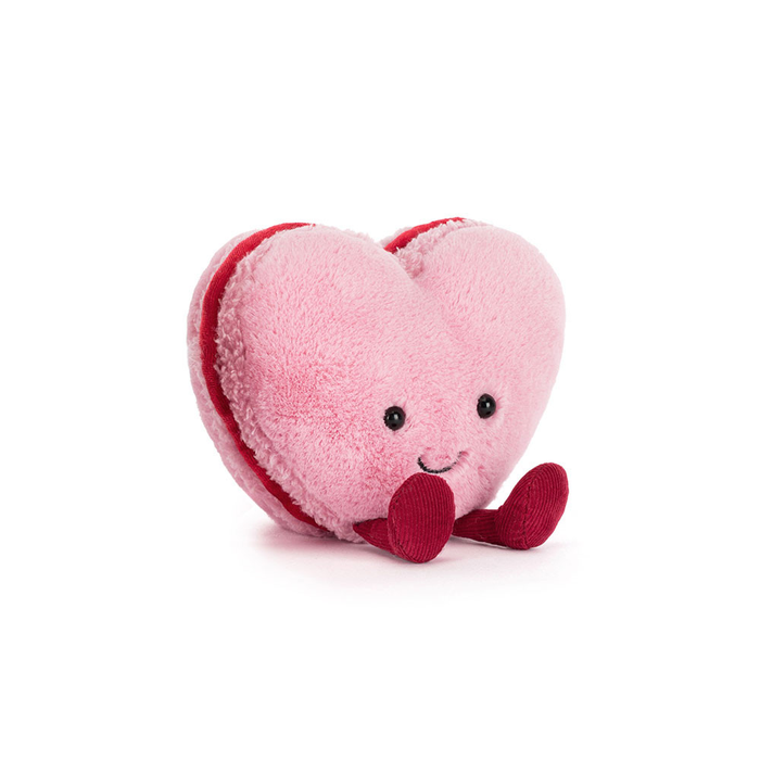 Heart-shaped plush toy with a smiling face on a white background