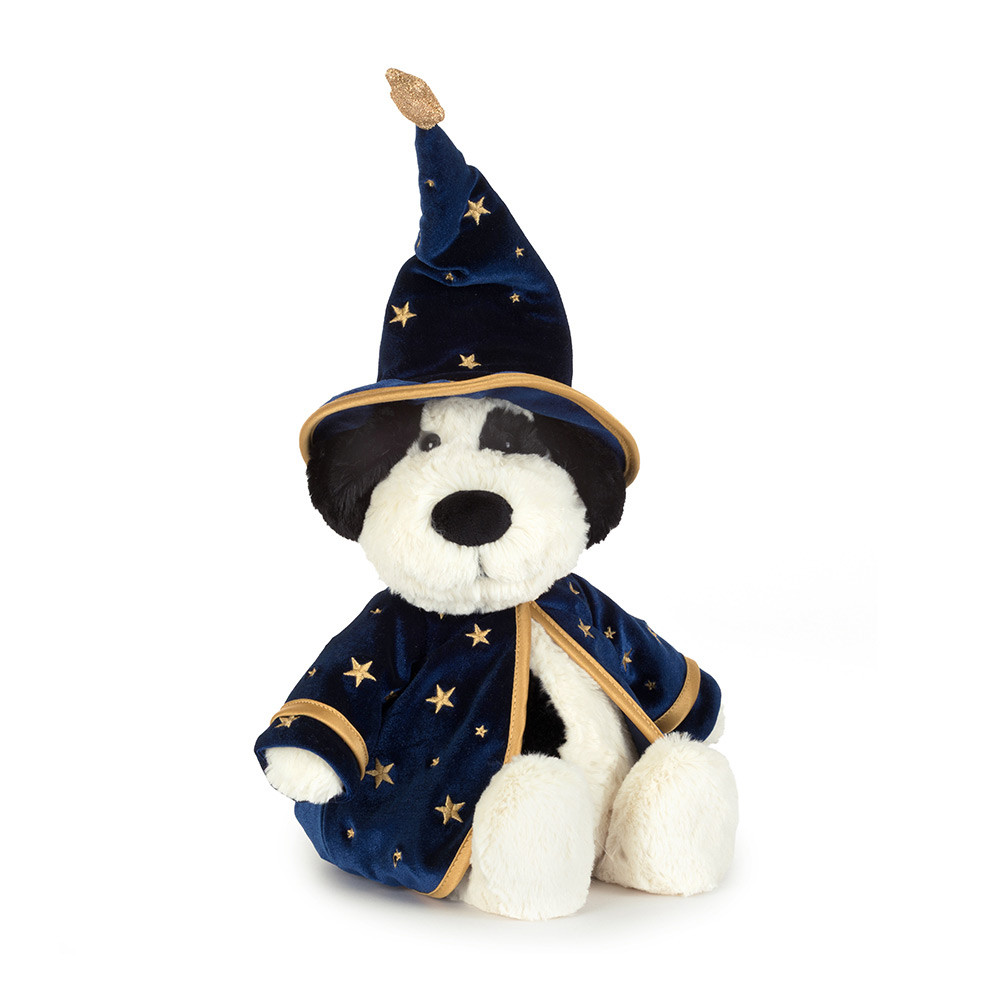 black and white puppy stuffed animal in a blue wizard costume with gold stars