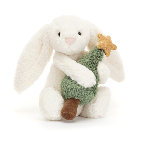 Plush bunny toy holding a green Christmas tree on a white background