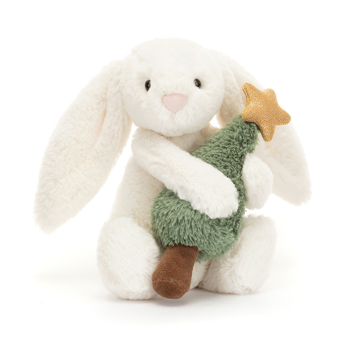 Plush bunny toy holding a green Christmas tree on a white background