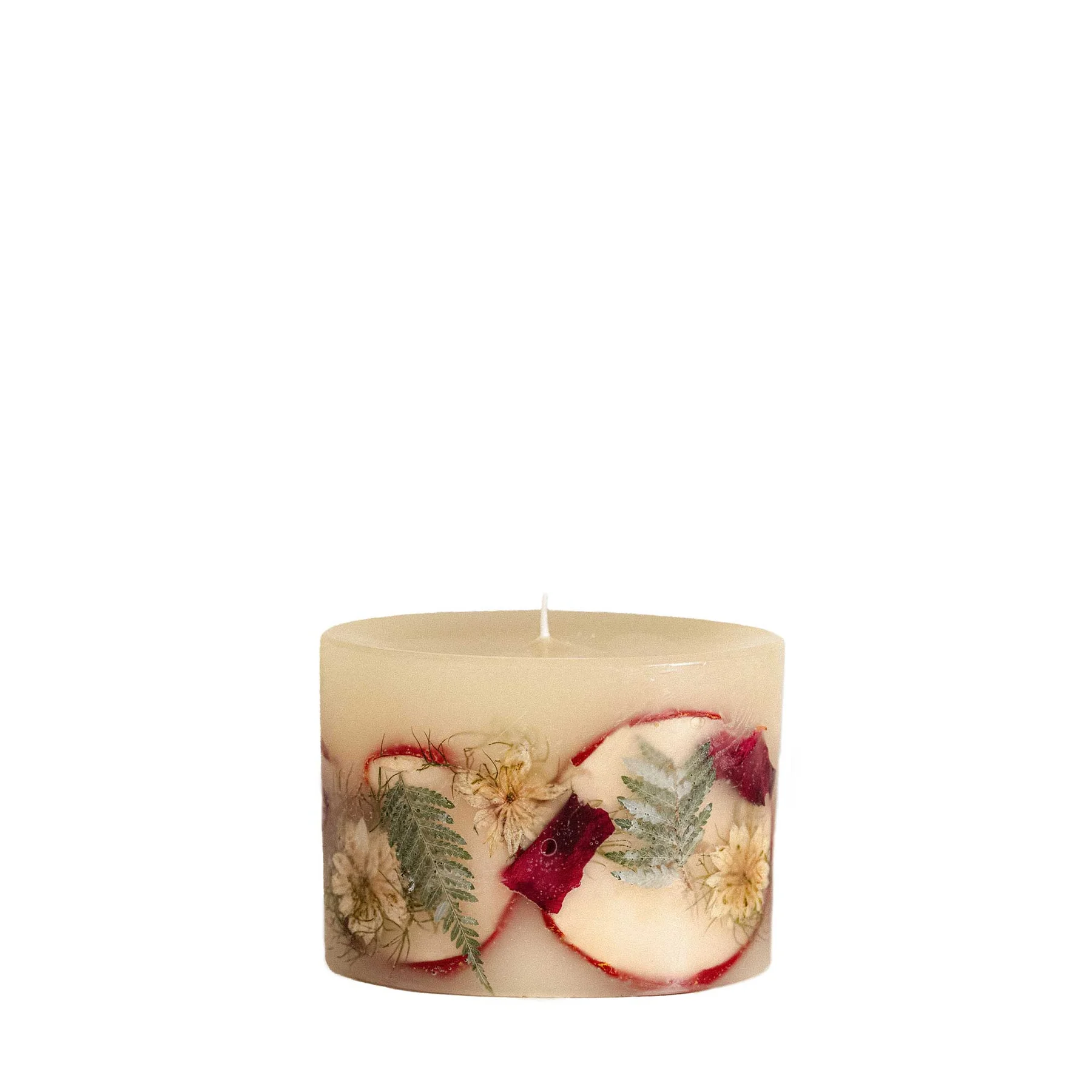 pillar candle with apple slices and flower pieces