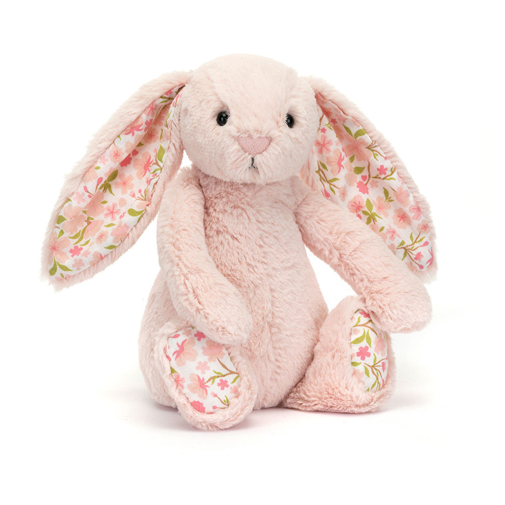 Floral-patterned plush bunny toy on a white background