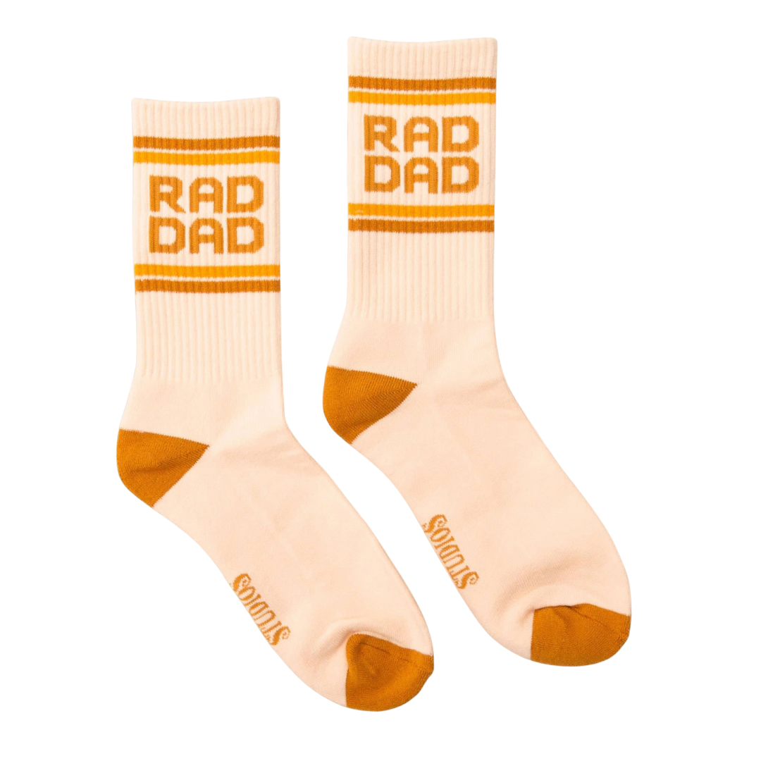 Beige socks with 'RAD DAD' text and orange accents on a white background