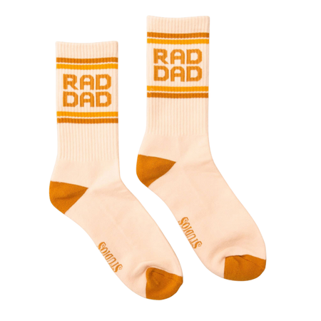 Beige socks with 'RAD DAD' text and orange accents on a white background